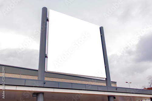 Mockup of the white blank square hanging logo sign in frame on the building wall or facade