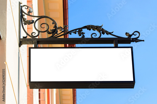 Mockup of the white blank square hanging logo sign in frame on the building wall or facade