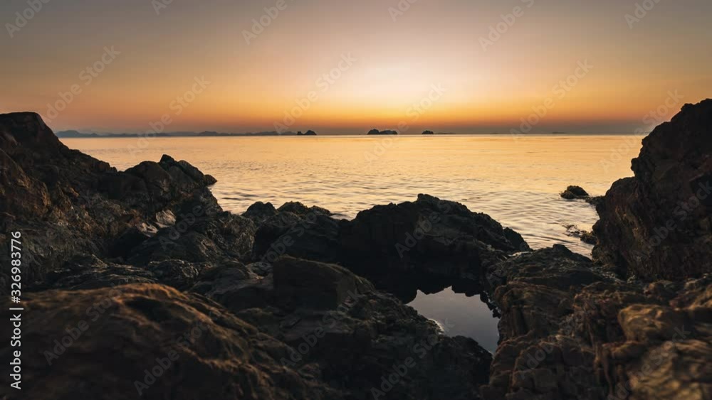 Sun sets over a sea lagoon with mountains in the background. 4k time lapse Sun sets over a sea lagoon with mountains in the background. 4k time lapse