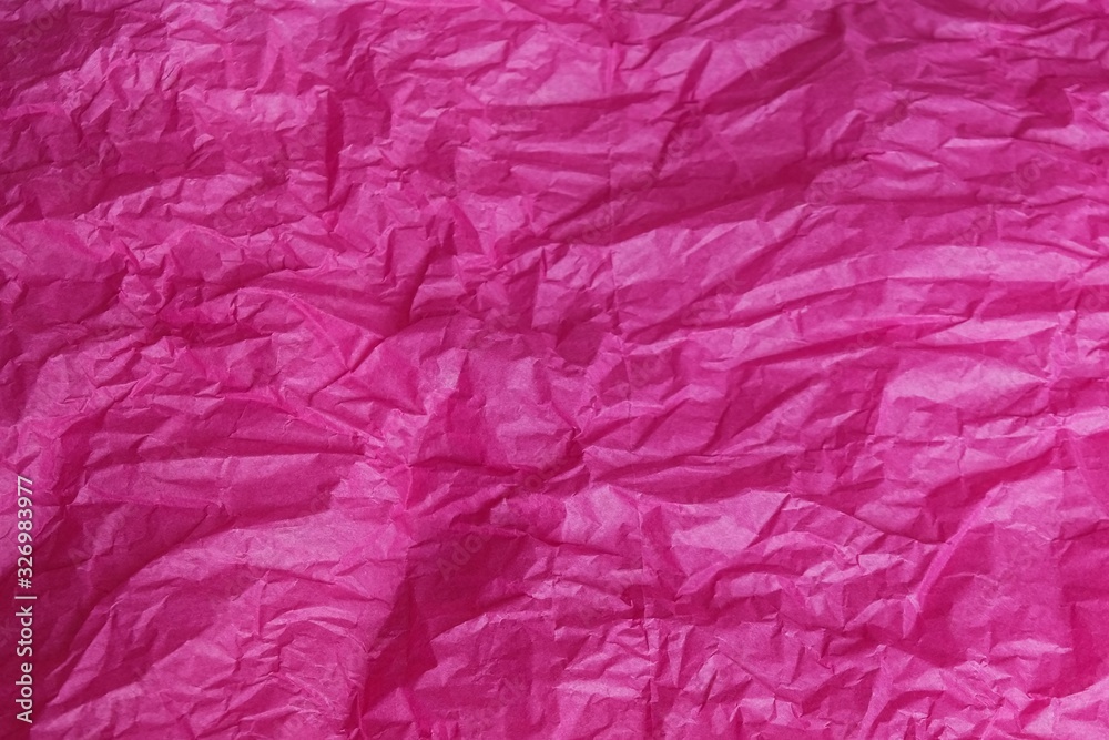 Crumpled pink magenta tissue paper for background or gift wrapping