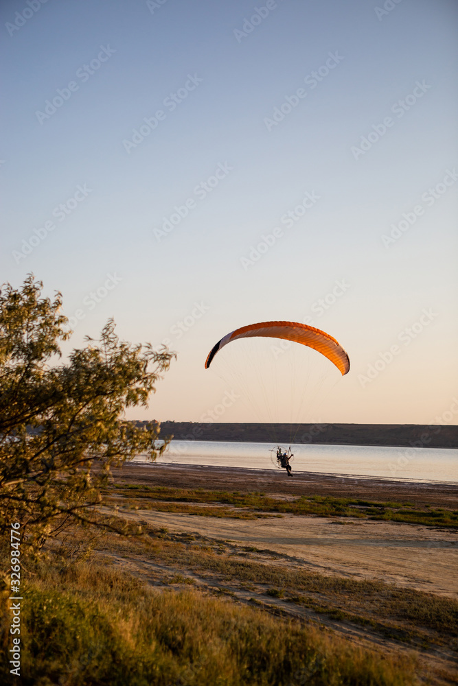 Paraglider on ground, starts to fly. Paraglider on ground, starts to fly.