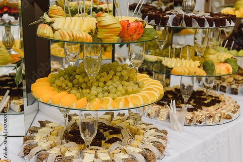 desserts with fruits, mousse, biscuits. Different types of sweet pastries, small colorful sweet cakes, macaron, and other desserts in the sweet buffet. candy bar for birthday photo