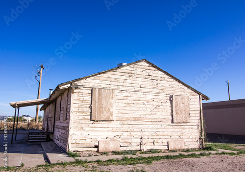 Old Weathered Home With Peeling Paint & Boarded Up Windows