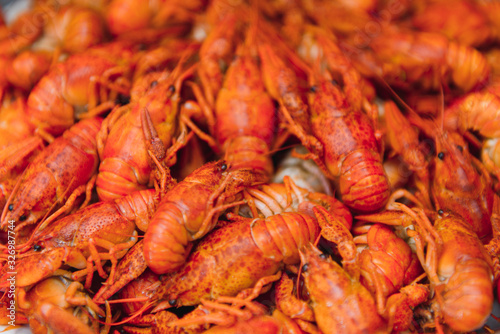 boiled crayfish on an iron plate. boiled red crayfish background for menu. top view, close up photo. a plate of cooked crayfish. Boiled crayfish, a traditional Russian dish. vintage photo processing