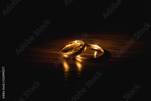 Beautiful wedding gold rings on dark background