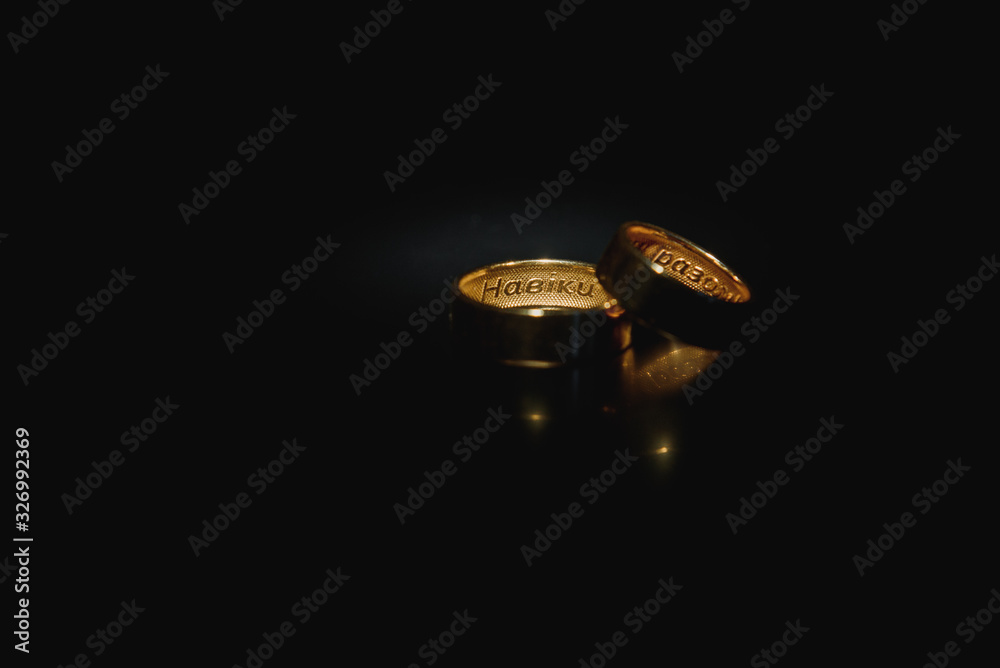 Beautiful wedding gold rings on dark background Beautiful wedding gold rings on dark background