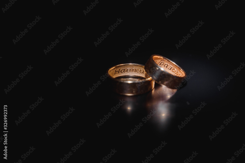 Beautiful wedding gold rings on dark background Beautiful wedding gold rings on dark background