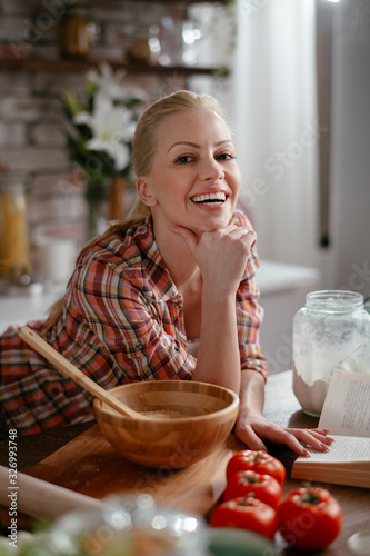 Woman in kitchen. Portrait of beautiful woman cooking.  © JustLife