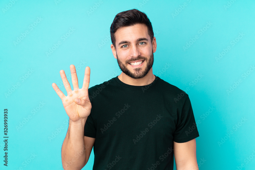 Caucasian handsome man isolated on blue background happy and counting four with fingers Caucasian handsome man isolated on blue background happy and counting four with fingers