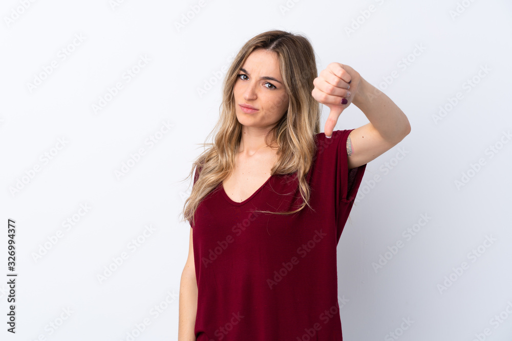 Young woman over isolated white background showing thumb down with negative expression Young woman over isolated white background showing thumb down with negative expression