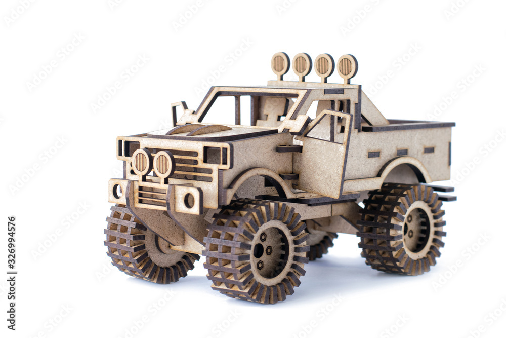Toy wooden car on a white isolated background Toy wooden car on a white isolated background
