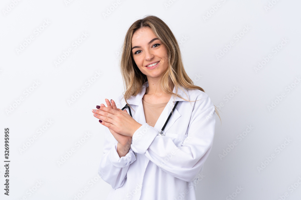 Young woman over isolated white background wearing a doctor gown and applauding Young woman over isolated white background wearing a doctor gown and applauding