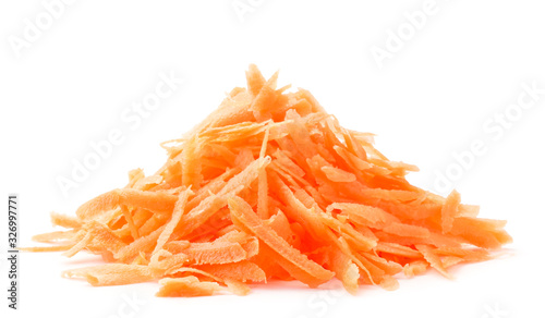 A pile of grated carrots in close-up on a white. Isolated