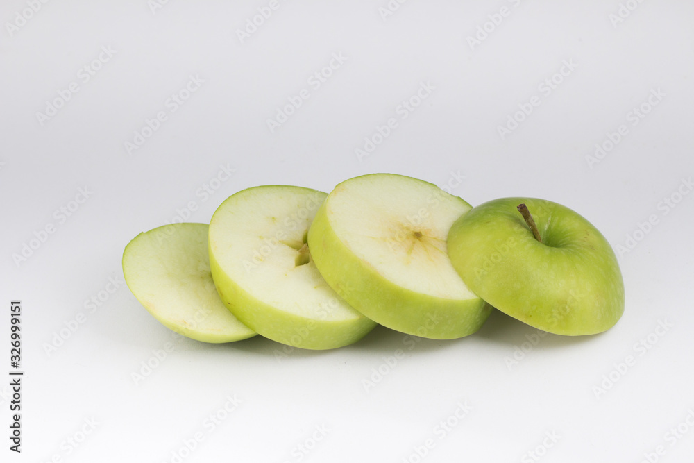 Top view closed up heap of green apple place on white floor. Sliced healthy green fruit. Top view closed up heap of green apple place on white floor. Sliced healthy green fruit.