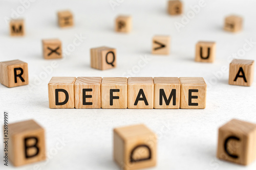 Фотография Defame - words from wooden blocks with letters, damage the good reputation defam