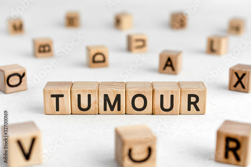 Quadro em tela Tumour - words from wooden blocks with letters, a mass of diseased cells tumour
