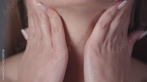 Wallpaper Mural Extreme close up shot of unrecognizable young woman applying lotion or cream to her neck Torontodigital.ca