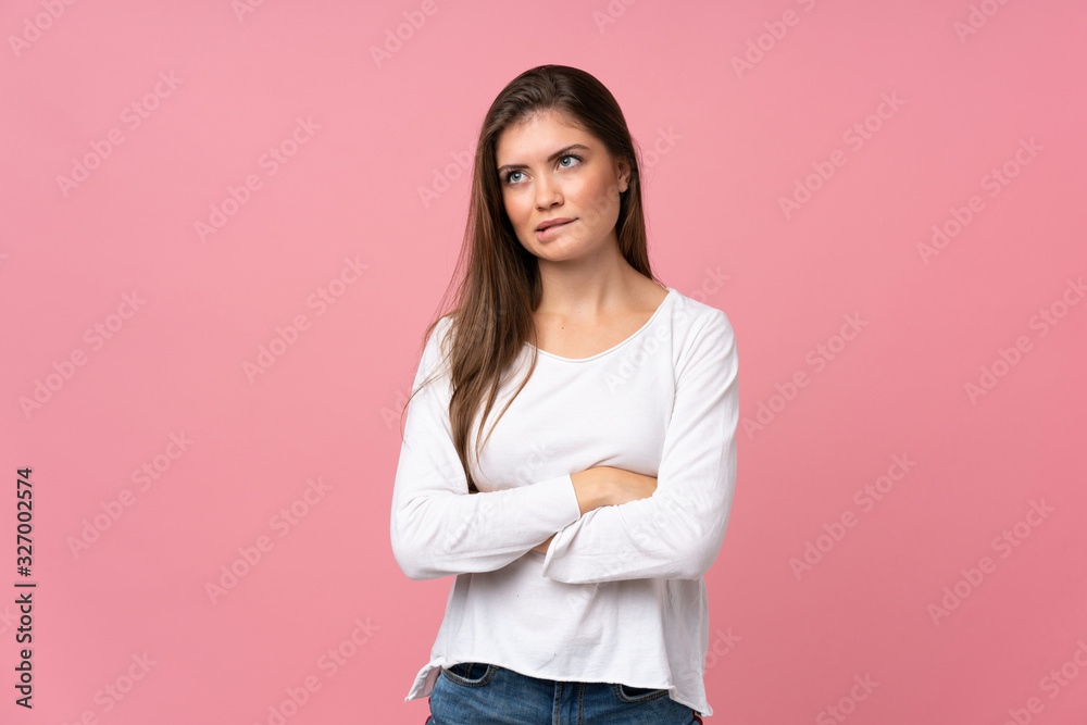 Young woman over isolated pink background with confuse face expression Young woman over isolated pink background with confuse face expression