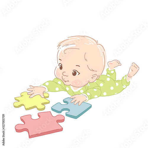 Cute little baby laying on stomach play puzzle.