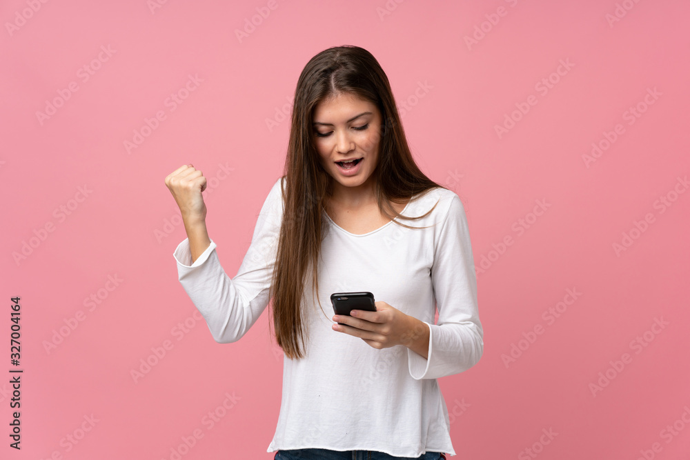 Young woman over isolated pink background surprised and sending a message Young woman over isolated pink background surprised and sending a message