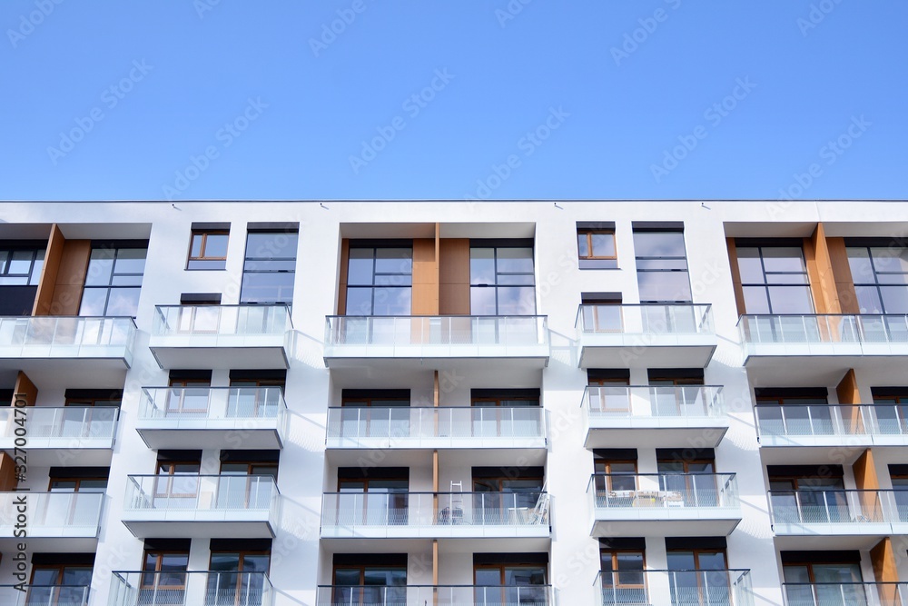 Contemporary residential building exterior in the daylight. Modern apartment buildings on a sunny day with a blue sky. Facade of a modern apartment building Contemporary residential building exterior in the daylight. Modern apartment buildings on a sunny day with a blue sky. Facade of a modern apartment building