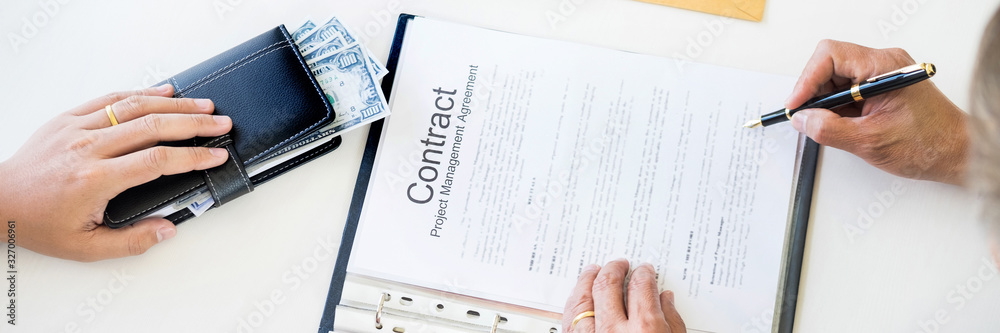 Businessman receive money in the envelope offered in file taking bribe and signing a contract - anti bribery and corruption concepts. Businessman receive money in the envelope offered in file taking bribe and signing a contract - anti bribery and corruption concepts.