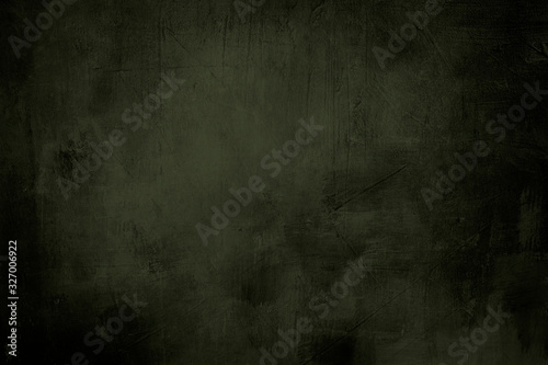 green grunge background or texture with dark vignette borders and spotlight