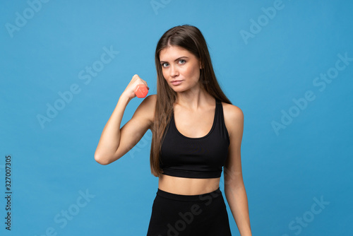 Young girl woman over isolated background making weightlifting
