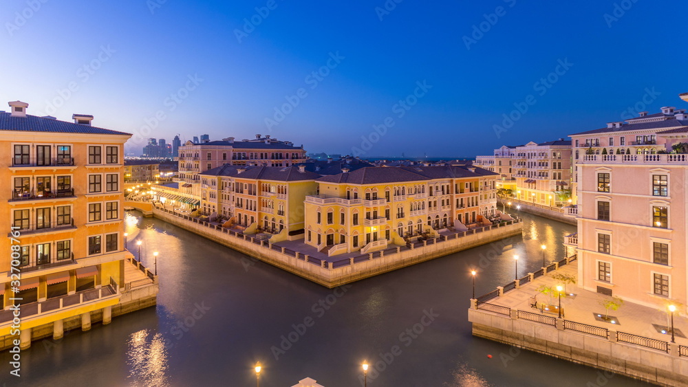 Canal aerial top view in Venice-like Qanat Quartier of the Pearl precinct of Doha day to night timelapse, Qatar.