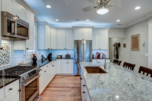 Fotografija Beautiful luxury kitchen with quartz and granite countertops and white cabinets