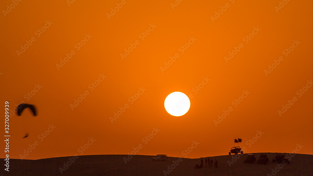 Buggies in sand desert at the sunset timelapse