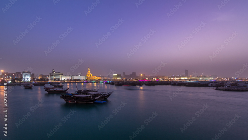 Evening at Doha Bay day to night timelapse with Traditional Wooden Dhow Fishing Boats.