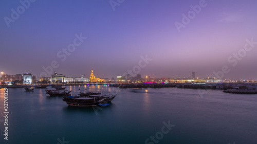 Evening at Doha Bay day to night timelapse with Traditional Wooden Dhow Fishing Boats.