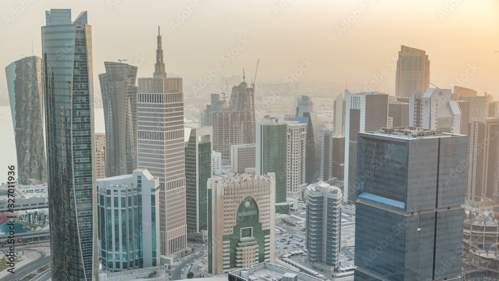 Obraz premium Skyscrapers before sunset timelapse in the skyline of commercial center of Doha, the capital Qatar