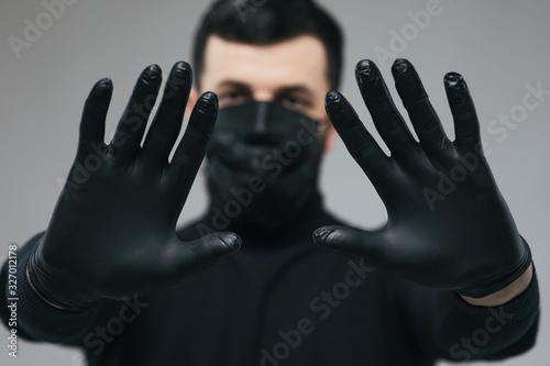 Man with medical mask for protection again influenza. Copy space for your text. Man with arms outstretched forward. Man wearing hygienic mask to prevent the virus and Coronavirus.