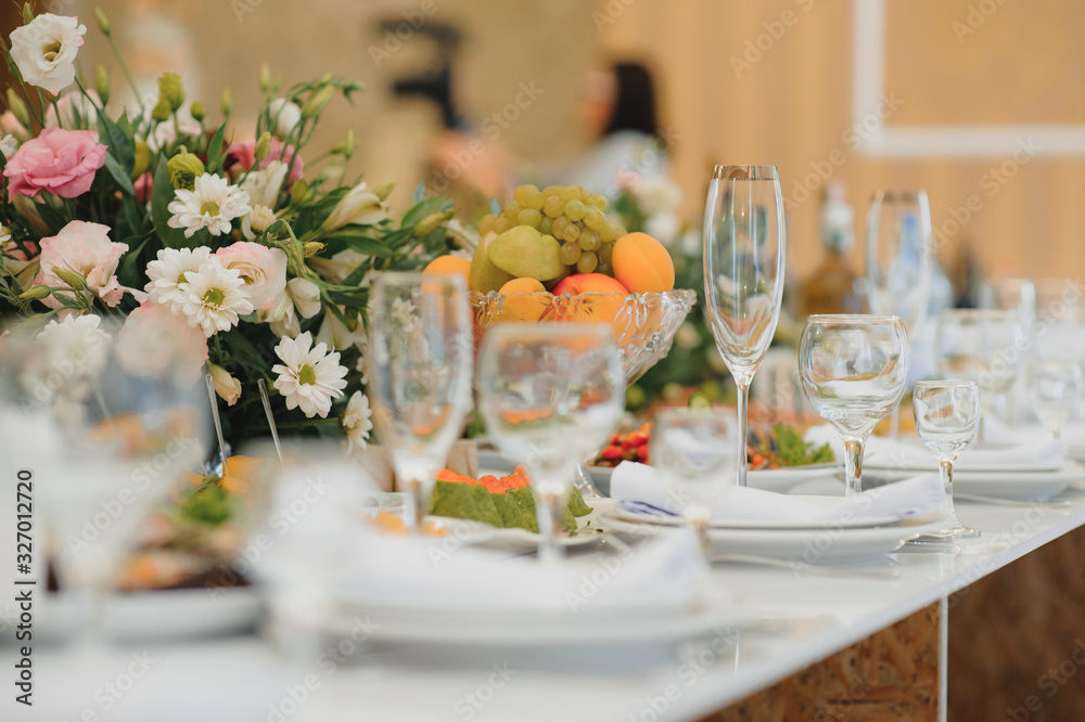 Glasses on the festive table setting. Wedding table decor concept. Table setting in classic style, setout. fine art. Glasses on the festive table setting. Wedding table decor concept. Table setting in classic style, setout. fine art.