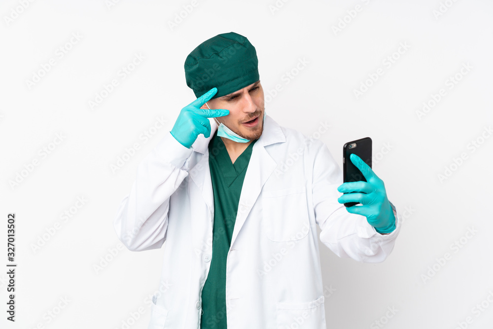 Surgeon in green uniform isolated on isolated white background making a selfie Surgeon in green uniform isolated on isolated white background making a selfie