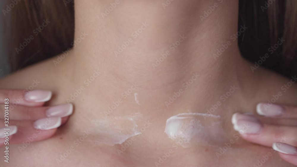 Extreme close up shot of unrecognizable woman gently massaging moisturizing cream into her skin Extreme close up shot of unrecognizable woman gently massaging moisturizing cream into her skin