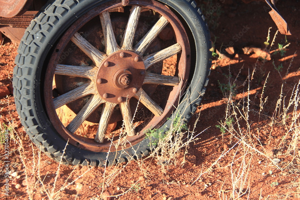 Wooden spoke wheel of rusting Model T Ford in the South Ausralian Outback