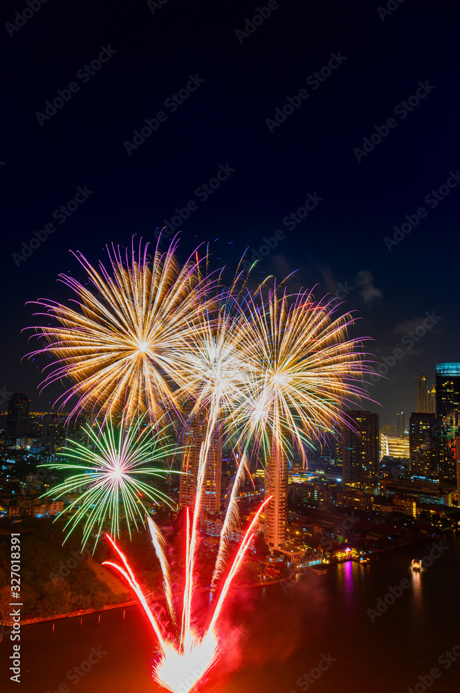 Beautiful firework display for celebration happy new year and merry christmas with Twilight night and firework lighting in bangkok cityscape background, Bangkok, Thailand.