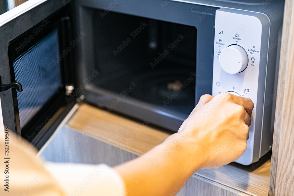 Using microwave oven, close up Using microwave oven, close up