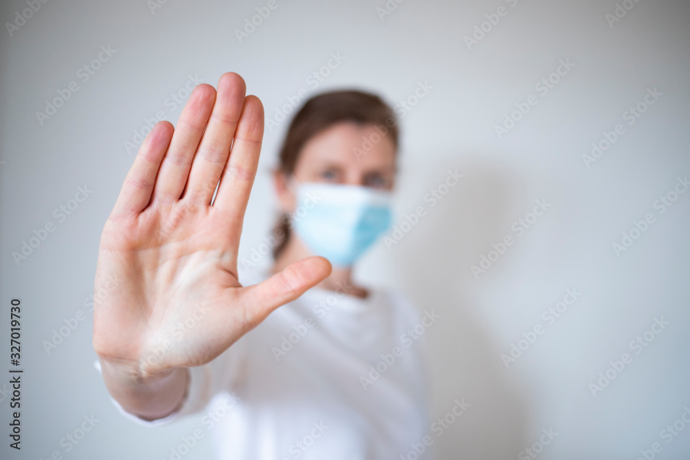 stop coronavirus woman wearing medical mask and raising hand 2019-nCoV fight - spreading - obrazy, fototapety, plakaty 