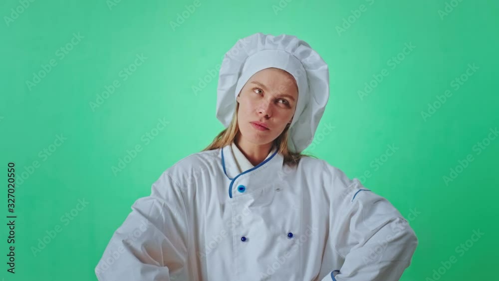 Blonde woman baker beautiful with a large smile excited make a fun face she are very emotional in front of the camera inside of a green studio background. 4k Blonde woman baker beautiful with a large smile excited make a fun face she are very emotional in front of the camera inside of a green studio background. 4k
