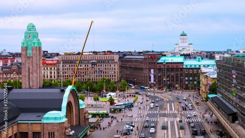 Helsinki, Finland. City center of Helsinki the capital of Finland. Time-lapse of people, car and tram traffic in front of the main railway station. Busy day in the city center, zoom in