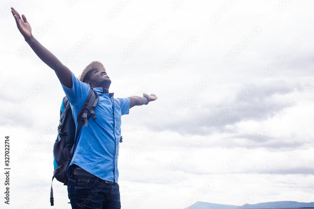 Freedom African man traveler standing with backpack Freedom African man traveler standing with backpack