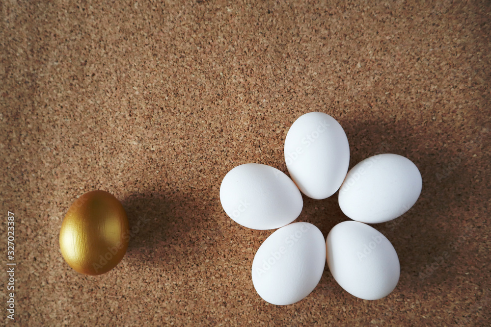 Golden and white eggs lie on the table in the form of a flower. Happy easter concept, top view, copy space. Golden and white eggs lie on the table in the form of a flower. Happy easter concept, top view, copy space.