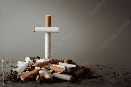 Stack of cigarette like graves.Cigarettes is addictive to be cancer.smoking reduction campaign in World No Tobacco Day. photo