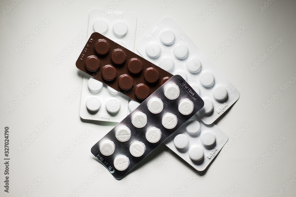 pills in plates on a white background pills in plates on a white background