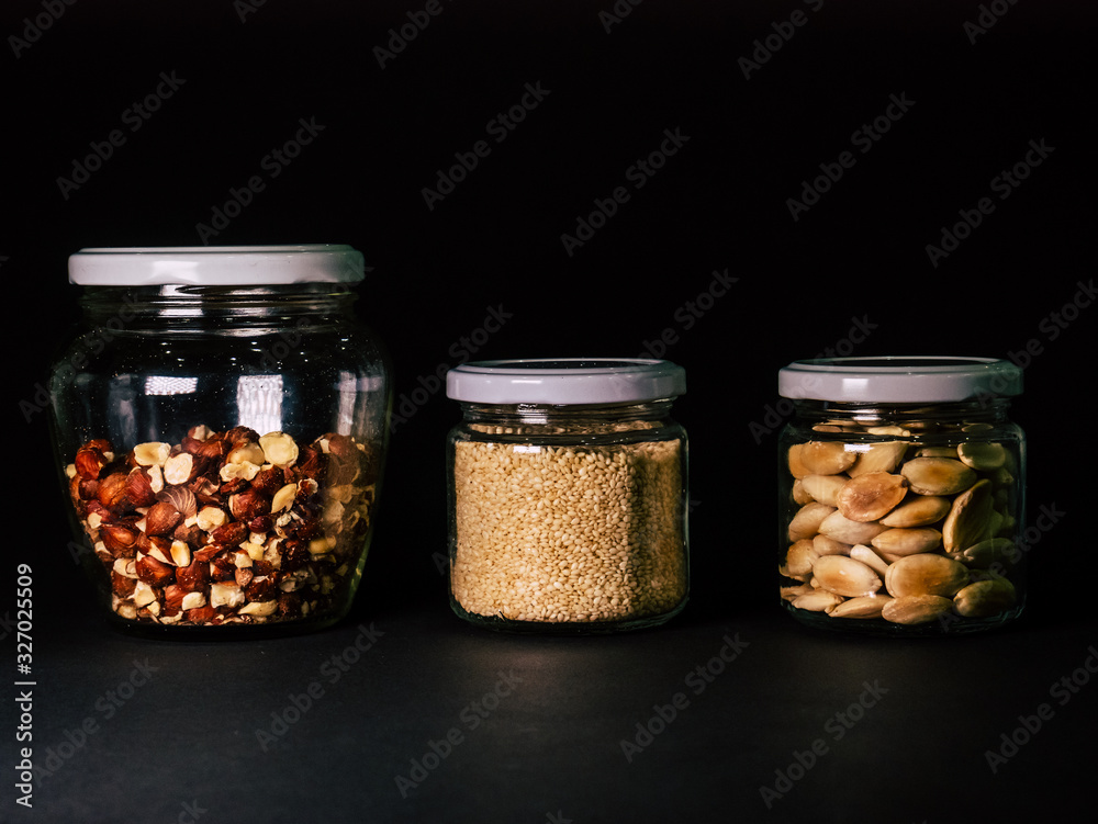 Almonds, hazelnut, jar of almonds on a black background Almonds, hazelnut, jar of almonds on a black background
