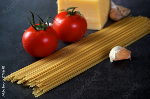 Spaghetti pasta with cheese tomatoes and garlic. Selective focus